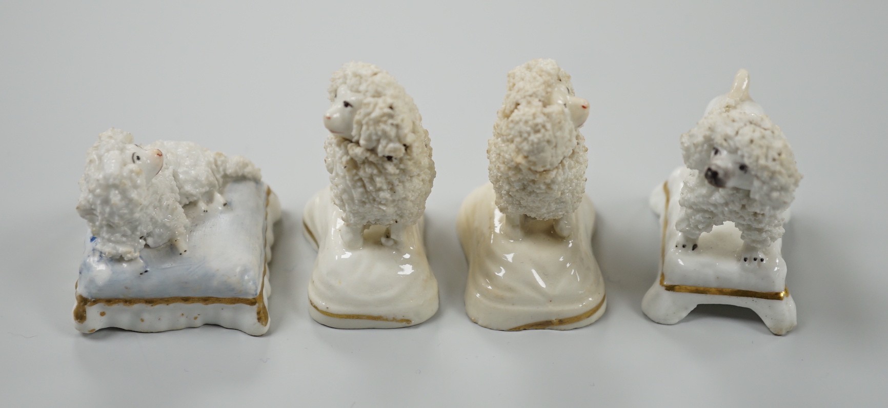 Four toy Staffordshire models of poodles, to include a pair, c.1830-50, (4). Tallest 5cm, Provence: Dennis G. Rice collection, Cf. Dennis G.Rice Dogs in English porcelain, colour plate 113